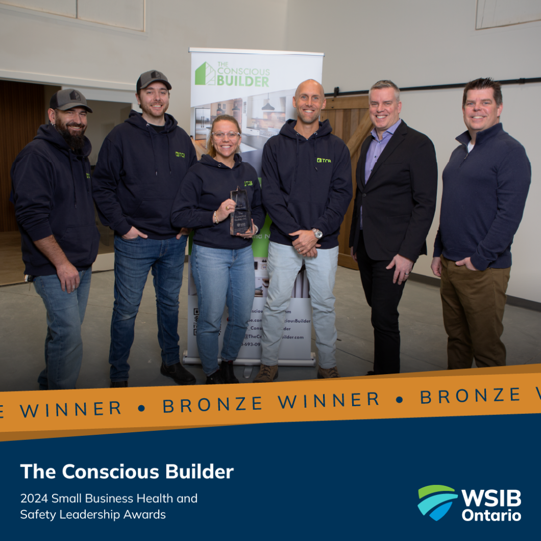 Rodney C. Cook (second from right), Vice President, and Martin Robert (right), Assistant Director of Workplace Health and Safety Services, present the bronze 2025 Small Business Health and Safety Leadership Award to The Conscious Builder team.